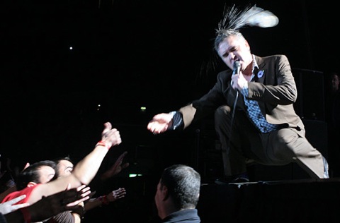 Morrissey is struck on the head with a water bottle during a performance at the Echo Arena on November 7, 2009 in Liverpool, England.